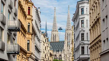 Spitzen von Gebäuden ragen über eine städtische Straße hinaus.