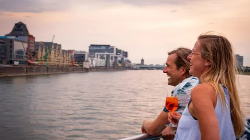 Couple enjoying cocktails on the riverbank in town.