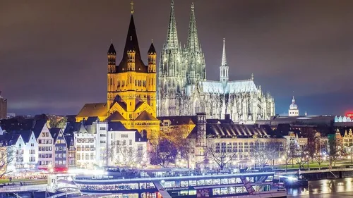 High Gothic cathedral rises above the illuminated city.