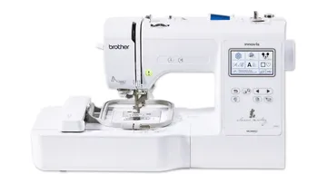 Sewing machine sews on a table with various designs.