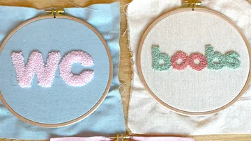 Embroidered words “WC” and “boobs” in frames.