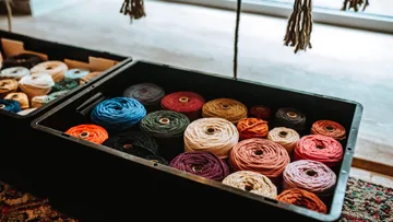 Colourful spools of thread in a box in the room