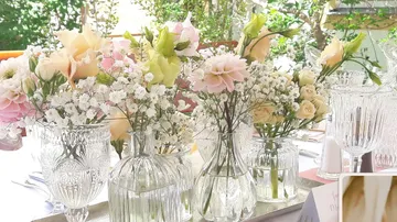 Elegant table setting with assorted floral centerpieces.