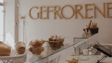 Ice cream cones and cups are in a retail store.