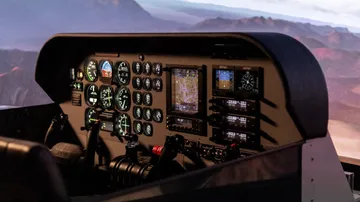 Cockpit with instruments shows flight navigation and control.