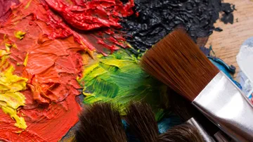 Color palette with brush, artist prepares colors.