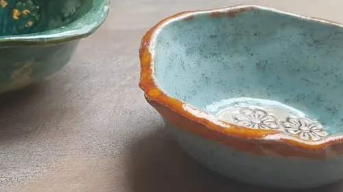 Blue bowl stands next to a green bowl on the table.