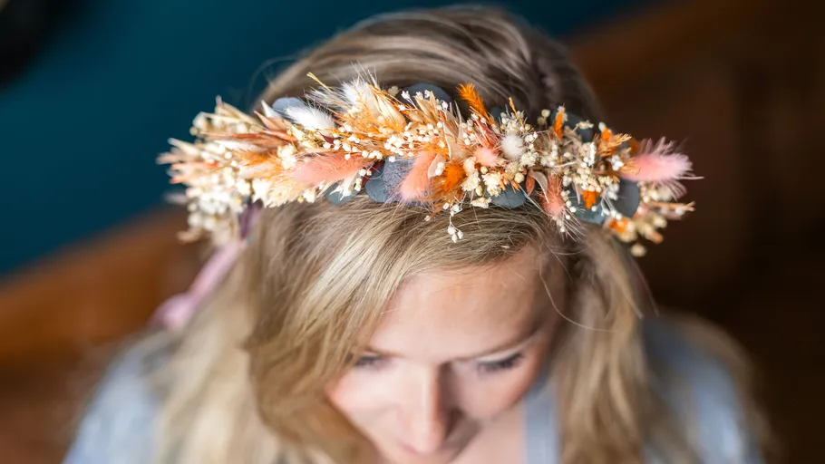 Colorful flower crown on woman's head.