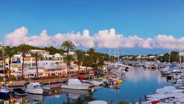 Harbours with yachts reflect the environment in the water.