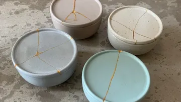 Four bowls, glued, stand on a grey surface.
