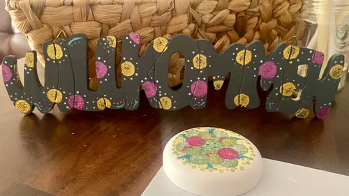 Colourful wooden lettering says “Welcome” on a table.