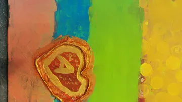 Heart-shaped paint on a colorful background, artistic work.