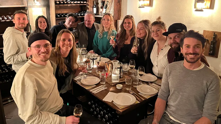 Gruppe von Menschen feiert am Tisch in Weinkeller.
