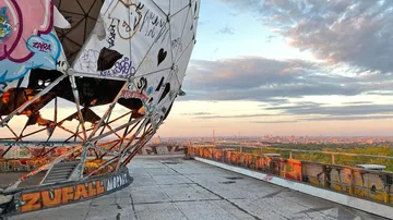 Graffiti-covered dome stands on the edge of a viewing terrace.