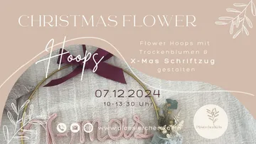 Blumenring mit Trockenblumen und Weihnachtsaufschrift gestaltet.