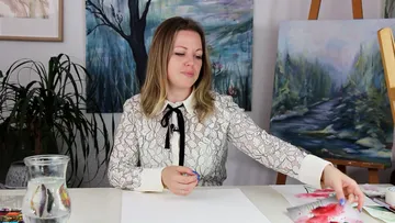 Woman drawing with pencil on blank paper at the table.