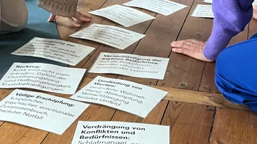 Maps with texts are viewed on the ground.