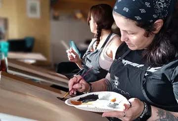 Two women painting in an art class.