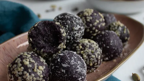 Round purple balls on a plate, with toppings.