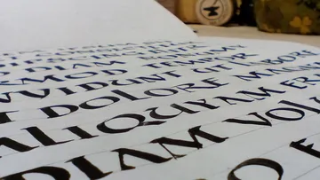Scroll with calligraphic text on a table.