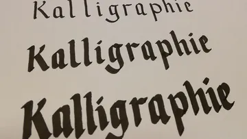 Calligraphy in various font styles on white paper.