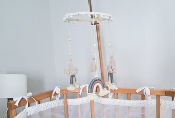Crib mobile with tassels and rainbows.
