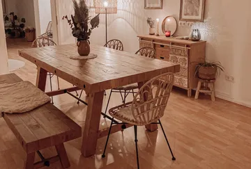 Gemütliches Esszimmer mit Holzmöbeln und warmer Beleuchtung.