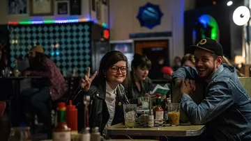 Young people are sitting in a restaurant laughing and relaxing.