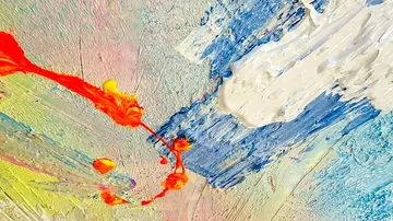 Colourful colours flow chaotically on a canvas surface.