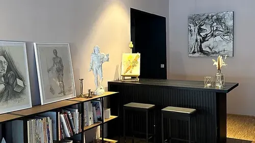 Modern bar with works of art and bookshelf in the room.