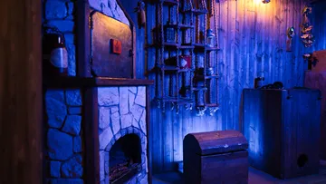 A brick oven is in a dimly lit room.