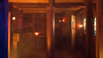 Dark room with wooden elements and low light.