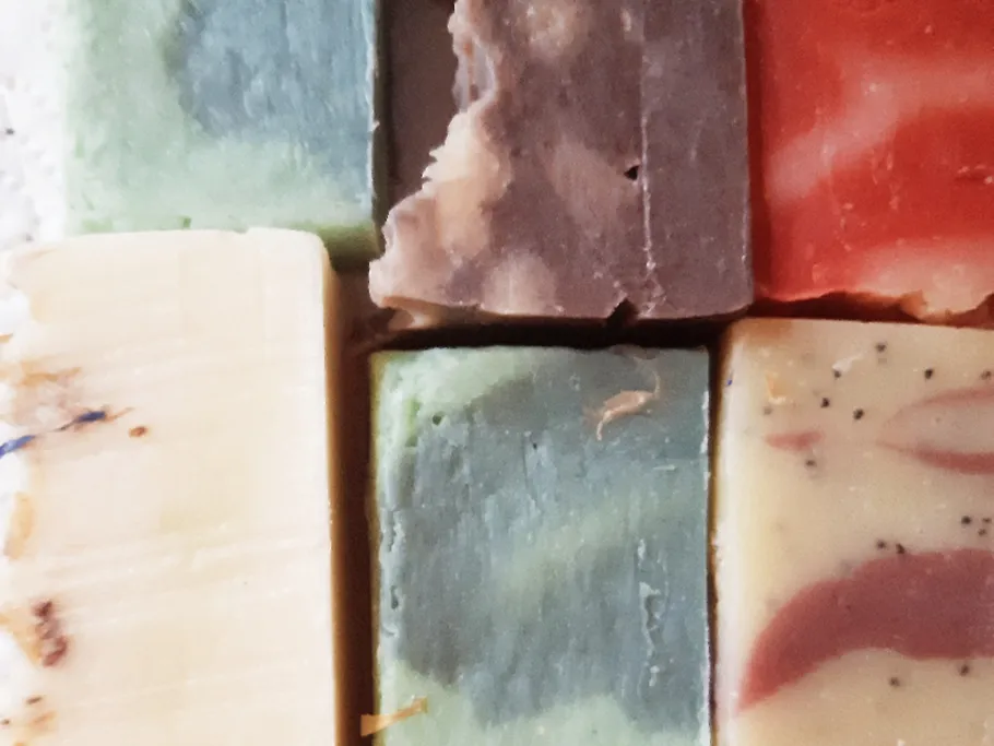 Bars of soap lie side by side on a surface.