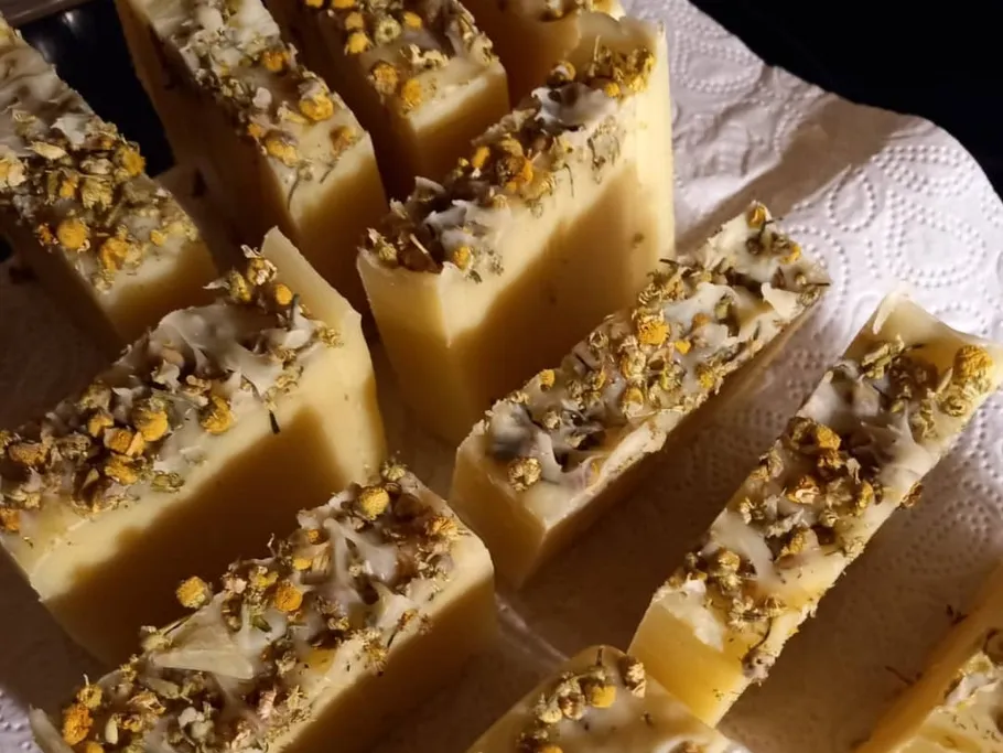 Bars of soap lie on a paper towel, decorated with flowers.