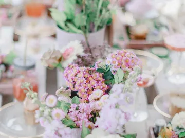 Colourful floral arrangements decorate a festive table.