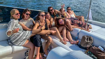 Group of women laughing on a boat.