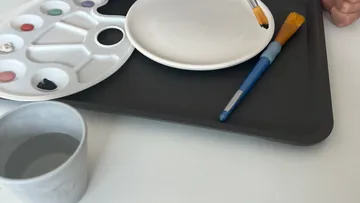 Brush and palette on a table ready to paint