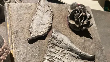 Three decorative objects lie on a used surface.