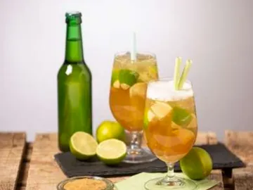 Zwei Cocktails mit Limetten stehen auf einem Tisch.
