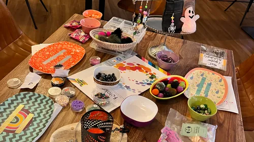 Colourful craft materials are on a table to design.