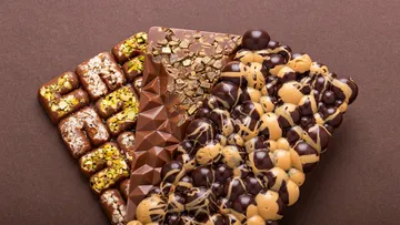 Three chocolate bars lie on a brown background.