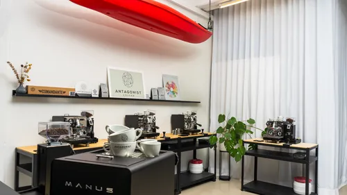 Coffee makers have an effect in a modern room with minimalistic furnishings.