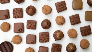 Chocolates and chocolates are neatly laid out on a table.