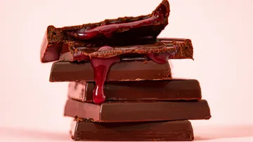 Dark chocolate melts and drips on a table.