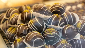 Chocolate truffles stand on top of each other, sweet and decorated.