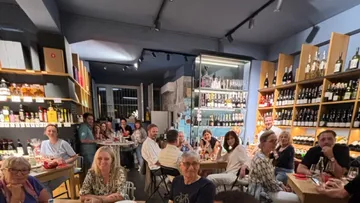 A group of people are sitting in a restaurant and smiling.