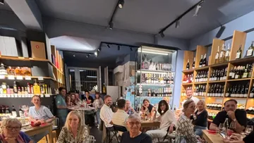 People sit, talk and enjoy drinks in a restaurant.
