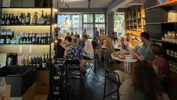A restaurant, people eating and drinking, warm atmosphere.