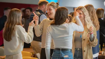 Gruppen von Frauen kommunizieren und lachen in einem Café.