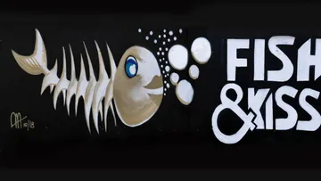 Graffiti of a fish blowing bubbles, “FISH & KISS.”